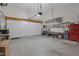 Spacious two car garage with an automatic door, tools, and storage units at 200 Holly Branch Dr, Holly Springs, NC 27540