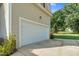 A side view of the garage highlights the home's exterior siding and an easy access driveway at 200 Holly Branch Dr, Holly Springs, NC 27540