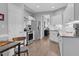 Bright kitchen with stainless appliances and white cabinets leading to dining area at 200 Holly Branch Dr, Holly Springs, NC 27540