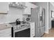Modern kitchen has stainless steel appliances, granite countertops and white cabinets at 200 Holly Branch Dr, Holly Springs, NC 27540