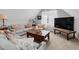 Inviting living room with plush sofas, decorative pillows, and a large television at 200 Holly Branch Dr, Holly Springs, NC 27540