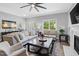 Cozy living room showing a fireplace, comfortable sofa, and natural light at 200 Holly Branch Dr, Holly Springs, NC 27540