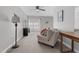 Relaxing living room with comfortable seating, a stylish lamp, a ceiling fan and a desk with natural lighting at 200 Holly Branch Dr, Holly Springs, NC 27540