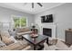 Comfortable living room showcases a fireplace and bright window views at 200 Holly Branch Dr, Holly Springs, NC 27540