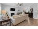 Open concept living room features a cozy fireplace and hardwood flooring at 200 Holly Branch Dr, Holly Springs, NC 27540