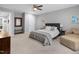Spacious main bedroom featuring soft lighting, neutral decor, and a comfortable bed at 200 Holly Branch Dr, Holly Springs, NC 27540