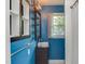 Stylish bathroom featuring blue walls, unique fixtures, and bright natural light at 2009 Carolina Ave, Durham, NC 27705