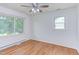 Bright bedroom with hardwood floors and plenty of natural light from large windows at 2009 Carolina Ave, Durham, NC 27705
