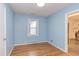 Cozy bedroom with hardwood floors, a window for natural light, and neutral walls at 2009 Carolina Ave, Durham, NC 27705