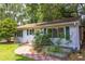 Charming single-story home featuring a well-manicured lawn, inviting entrance, and landscaped garden beds at 2009 Carolina Ave, Durham, NC 27705
