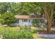 Charming single-story home featuring a well-manicured lawn, inviting entrance, and landscaped garden beds at 2009 Carolina Ave, Durham, NC 27705
