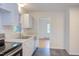 Functional kitchen with stainless steel appliances, white cabinets, and slate flooring for a modern touch at 2009 Carolina Ave, Durham, NC 27705