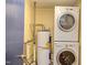 Laundry area with stackable washer and dryer, water heater, and utility connections at 2009 Carolina Ave, Durham, NC 27705