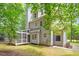 Spacious backyard featuring a screened-in porch, mature trees, and a well-manicured lawn at 201 Cobblestone Dr, Chapel Hill, NC 27516