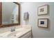 Bathroom vanity with decorative mirror and framed artwork at 201 Cobblestone Dr, Chapel Hill, NC 27516