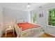 Charming bedroom with bright light, a large bed, and paneled walls at 201 Cobblestone Dr, Chapel Hill, NC 27516