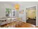 Cozy dining area with a large window, pendant lighting, and hardwood floors at 201 Cobblestone Dr, Chapel Hill, NC 27516