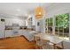 Bright kitchen features white cabinets, stainless steel appliances, granite counters, and a view of the backyard at 201 Cobblestone Dr, Chapel Hill, NC 27516