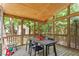 Screened porch with wood ceiling and a dining table at 201 Cobblestone Dr, Chapel Hill, NC 27516