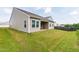 Large backyard with green grass, back of the house, and a wooden privacy fence at 202 E Painted Way, Clayton, NC 27527