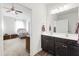 Bathroom features double vanity, dark cabinets, and a view into a bedroom at 202 E Painted Way, Clayton, NC 27527