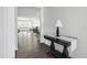 Bright foyer with wood flooring, showcasing an elegant table and a glimpse into the open living space at 202 E Painted Way, Clayton, NC 27527