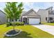 Charming home with a stone accent facade, well-manicured lawn, and a two-car garage at 202 E Painted Way, Clayton, NC 27527