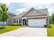 Attractive home with stone detail, a two-car garage, and a welcoming front yard in a neighborhood at 202 E Painted Way, Clayton, NC 27527