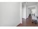 Bright hallway featuring hard floors, white walls, and a charming side table with a lamp at 202 E Painted Way, Clayton, NC 27527