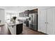 Modern kitchen with stainless steel appliances, granite countertops, and dark wood cabinets at 202 E Painted Way, Clayton, NC 27527