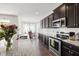 Well-appointed kitchen featuring stainless steel appliances, granite countertops, and dark cabinetry at 202 E Painted Way, Clayton, NC 27527