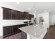 Contemporary kitchen features granite countertops, a large island, and stainless steel appliances at 202 E Painted Way, Clayton, NC 27527