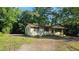 Charming single-story home surrounded by lush trees, featuring a cozy exterior at 2100 N Webb St, Selma, NC 27576