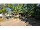 Modest single-story home with a rustic, woodsy feel and a shaded carport at 2100 N Webb St, Selma, NC 27576
