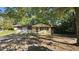 Quaint single-story home nestled among trees, with siding and charming shutters at 2100 N Webb St, Selma, NC 27576