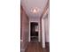 Hallway featuring hardwood floors and access to rooms with natural lighting at 2100 N Webb St, Selma, NC 27576