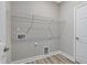 Clean laundry room features modern white walls, luxury vinyl plank flooring, and hookups for laundry machines at 226 Faith Avenue, Sanford, NC 27330