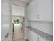 Pantry with white cabinets, granite countertop, and stainless steel appliances located just off the kitchen at 226 Faith Avenue, Sanford, NC 27330