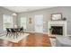 Hardwood floors in open floor plan dining area with fireplace, and bright natural light at 2309 King Malcolm Ln, Zebulon, NC 27597