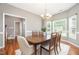 Bright dining room with wood floors, chandelier, and large windows at 2309 King Malcolm Ln, Zebulon, NC 27597