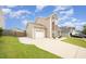 Two-story house with an attached garage, long driveway, and well-maintained lawn at 2309 King Malcolm Ln, Zebulon, NC 27597