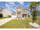Well-kept two-story house featuring an attached garage, lush lawn, and inviting front entrance at 2309 King Malcolm Ln, Zebulon, NC 27597