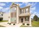 Inviting two-story home with mixed siding, covered porch, manicured front yard, and professional landscaping at 2309 King Malcolm Ln, Zebulon, NC 27597