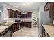 Cozy kitchen featuring dark cabinets, stainless steel appliances, and tile flooring at 2309 King Malcolm Ln, Zebulon, NC 27597