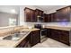 Modern kitchen with granite countertops, stainless steel appliances, and mosaic tile backsplash at 2309 King Malcolm Ln, Zebulon, NC 27597