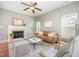 Comfortable living room with fireplace, hardwood floors, ceiling fan, and ample light at 2309 King Malcolm Ln, Zebulon, NC 27597