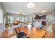Open-concept living room with modern furnishings, fireplace, and hardwood floors that flows into the kitchen at 2309 King Malcolm Ln, Zebulon, NC 27597