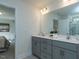 Bathroom with double vanity, grey cabinets, and contemporary fixtures at 233 Steel Spring Rd # 24, Angier, NC 27501