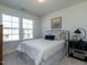 Bright bedroom with two windows, carpet flooring, and a black metal bed frame at 233 Steel Spring Rd # 24, Angier, NC 27501