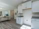 Bright open floor plan shows kitchen with white cabinets and open access to the living room at 233 Steel Spring Rd # 24, Angier, NC 27501